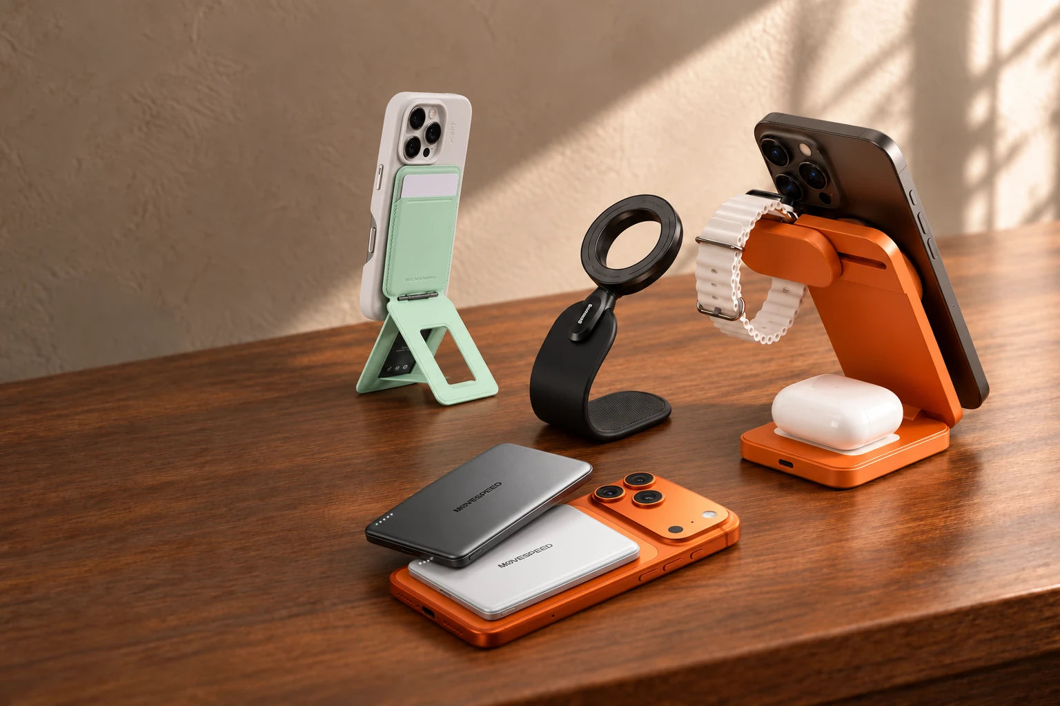 Mint wallet stand on a white phone, Baseus ring car mount, orange charging station, and silver and grey MOVE SPEED magnetic power banks on an orange phone.