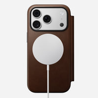 Nomad Modern Leather Folio in brown Camino leather for iPhone 18 Pro, back view on a MagSafe charger