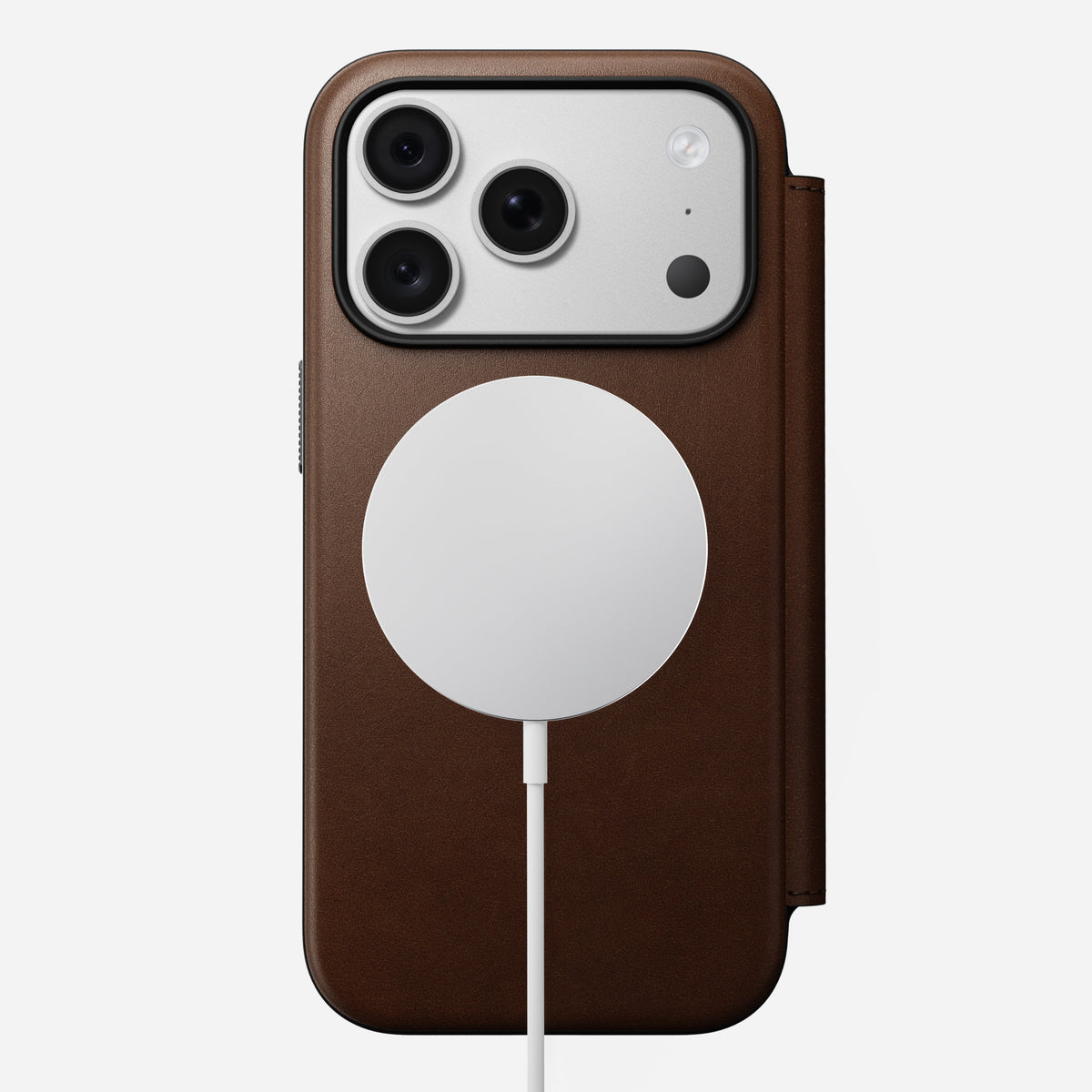 Nomad Modern Leather Folio in brown Camino leather for iPhone 18 Pro, back view on a MagSafe charger