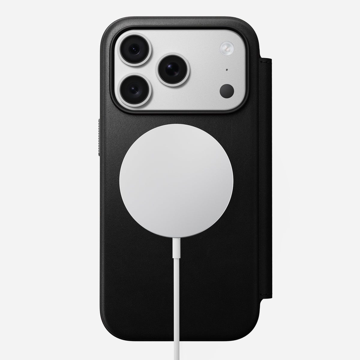 Nomad Modern Leather Folio in black Camino leather for iPhone 18 Pro, back view on a MagSafe charger