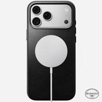 Angled view of the black Horween leather Nomad case on iPhone 18 Pro Max showing anodised aluminium side buttons
