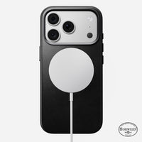 Angled view of the black Horween leather Nomad case on iPhone 18 Pro showing anodised aluminium side buttons